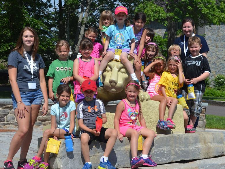 Group of children next to Nittany Lion statue