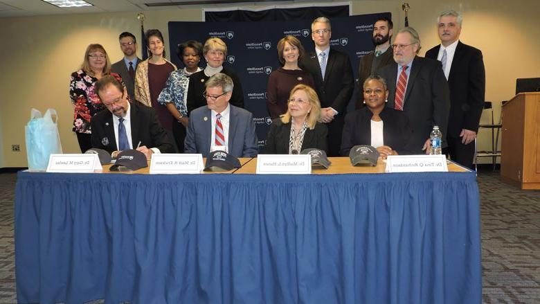 Administrators gather to sign articulation agreement