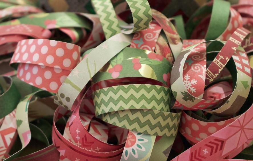 A close-up image of rolls of pink and green ribbon